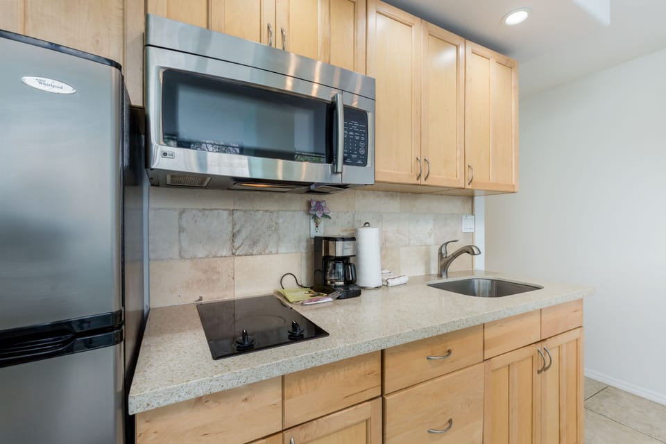 Your fully equipped kitchen features modern appliances, warm wood cabinetry, and ample counter space for preparing your favorite meals during your stay.