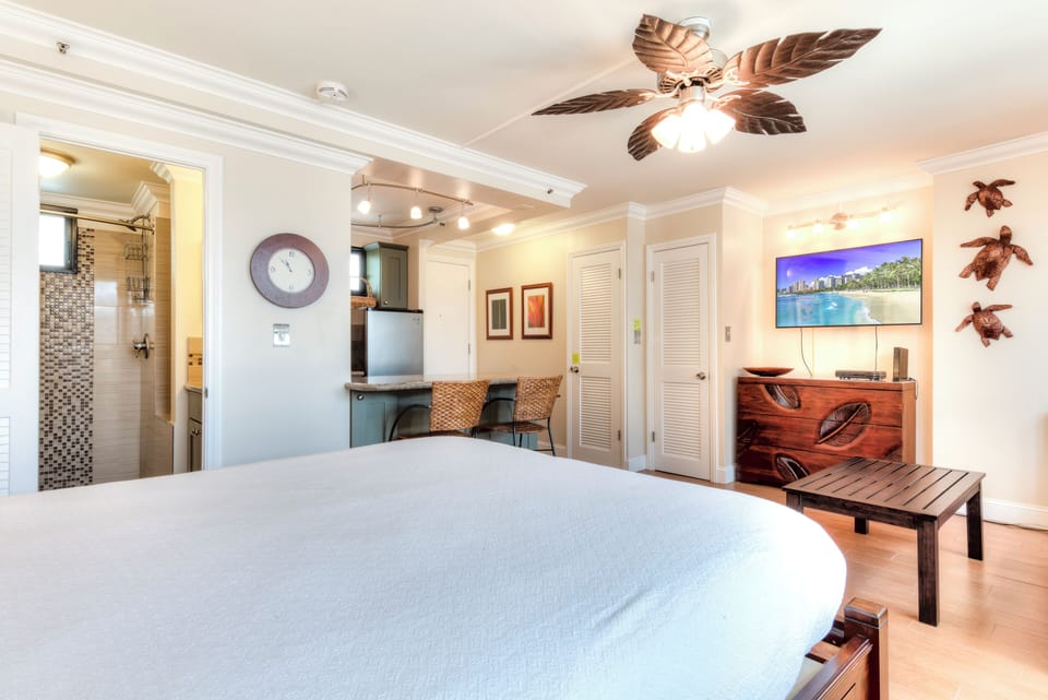 Drift off under tropical breezes in your island-themed studio, complete with kitchenette, cozy seating, and a sparkling en-suite bath just steps from your bed.