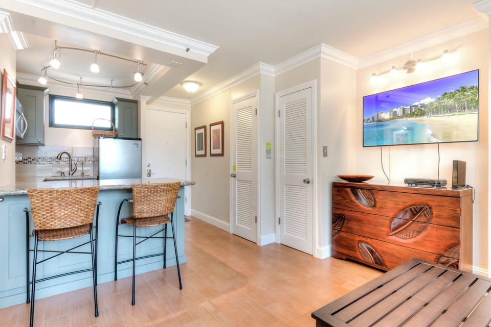 Unwind in your bright, open living space featuring a fully equipped kitchen with breakfast bar, stylish island seating, and a cozy entertainment area—your perfect home base for relaxing.