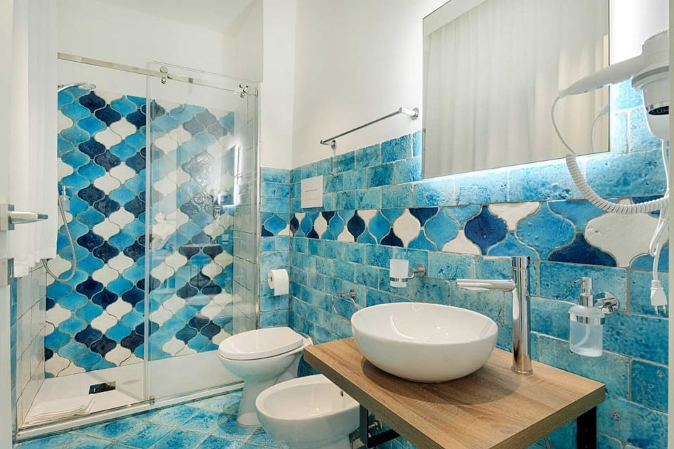 Triple Room, Courtyard View | Bathroom | Shower, hair dryer, towels, soap