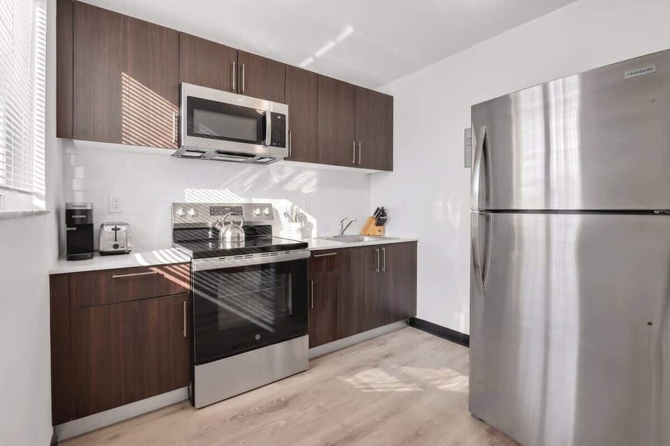 Cook with ease in the fully equipped kitchen featuring modern appliances, cookware, and all the essentials.