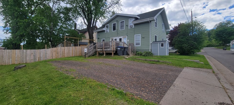 Back deck and parking area at Loon Lookout, part of a side-by-side townhome setting.