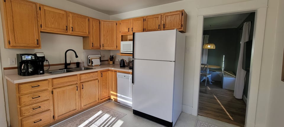 Kitchen with coffee maker, microwave, fridge, dishwasher, and the essentials for meals at home.