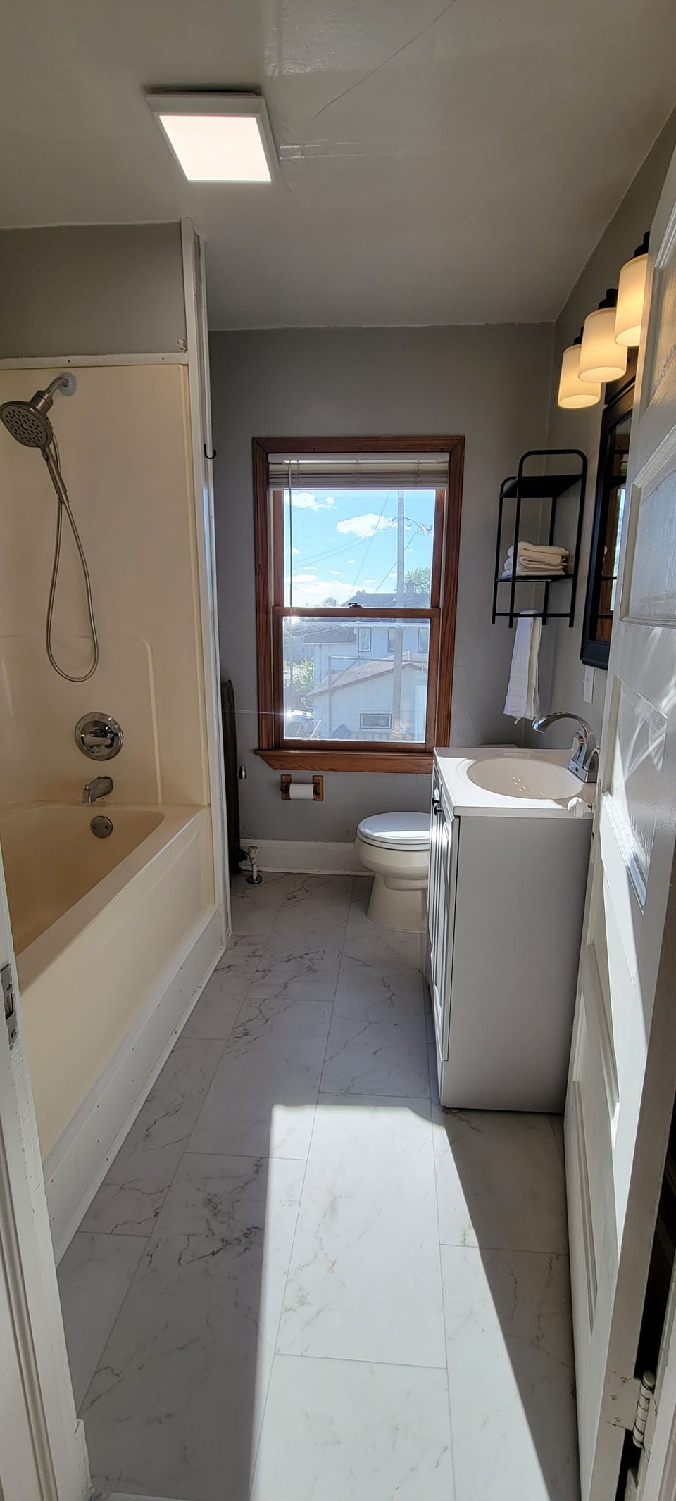 Full bathroom with bathtub/shower combination. Please note the raised 23.5-inch tub entry and lower-than-standard shower head.