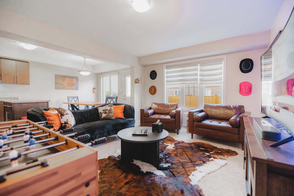 Kick back and enjoy your favorite movies and shows in a cozy living room designed for comfort, entertainment, and quality time together.