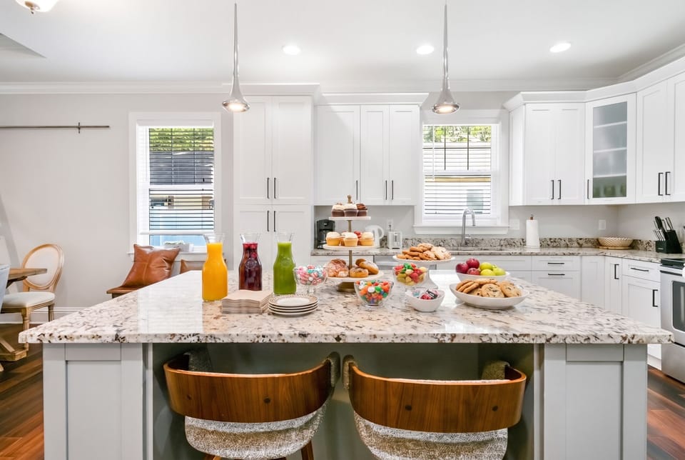 White cabinets, granite counters, and all the room you need to cook a real meal together. This kitchen was made for slowing down.