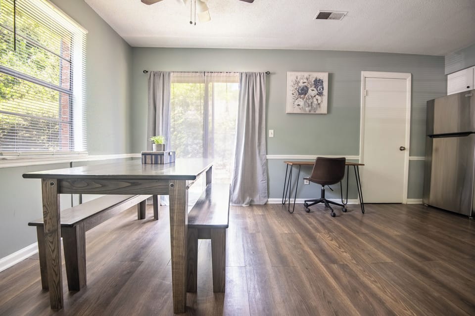 Gather around the dining table for shared meals, game nights, or planning the day's adventures, all in a bright space that flows easily into the kitchen. Notice the workspace right inside the dining/kitchen area.