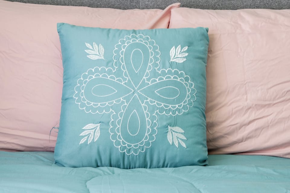 Drift off in cozy bedding accented with soft colors and thoughtful details that bring comfort and a welcoming feel to your stay.