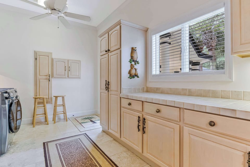 A full-size washer and dryer, built-in cabinetry, and a utility sink make this in-home laundry room a convenient perk for extended stays. Small touches like this make longer vacations easier to manage.

