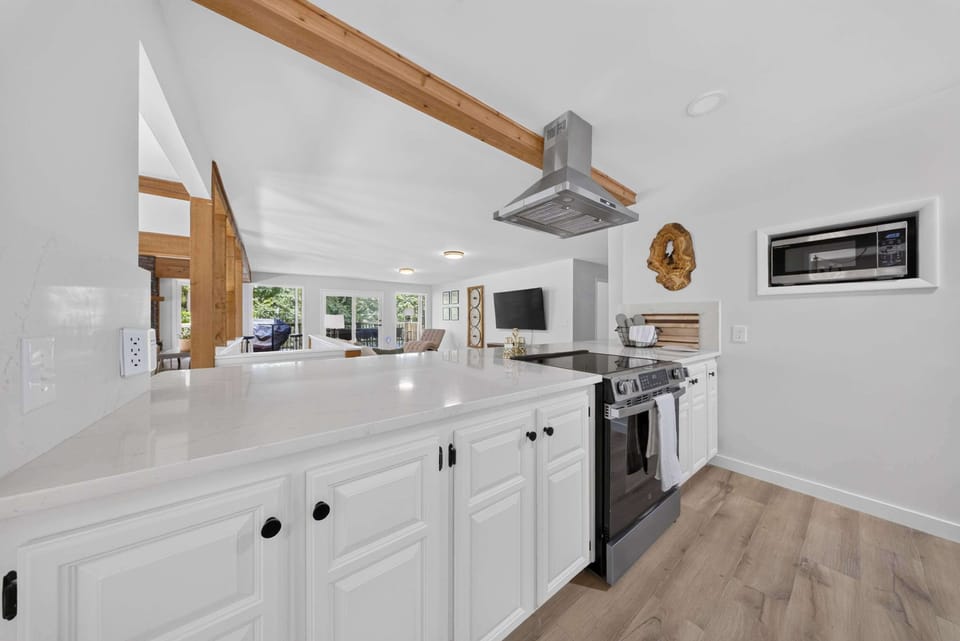 Fully equipped kitchen with stainless steel appliances and a full-size range