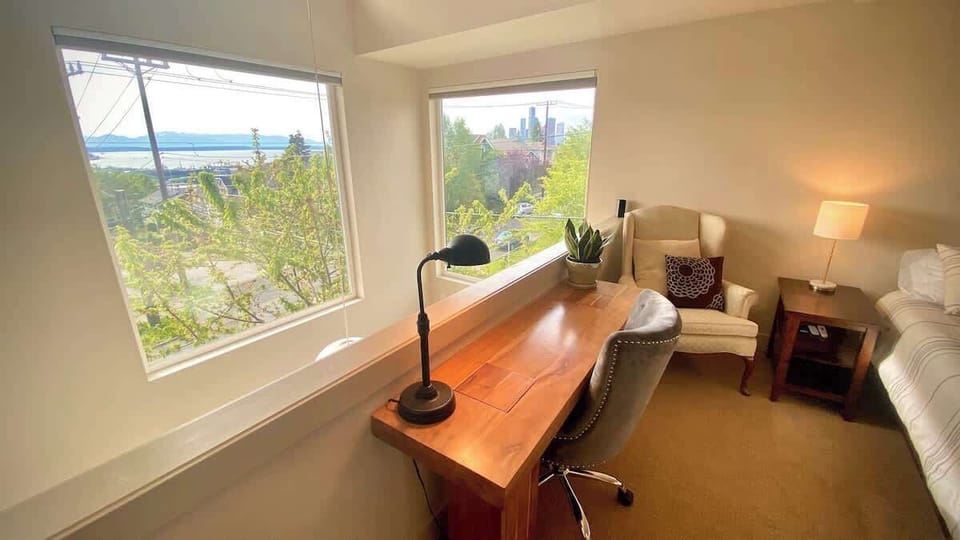 Gorgeous city, water, and mountain views from master bedroom desk. Enjoy lightning-fast gigabit fiber internet from home