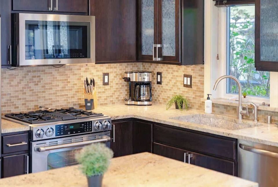 Modern kitchen features high-end appliances and gas range 