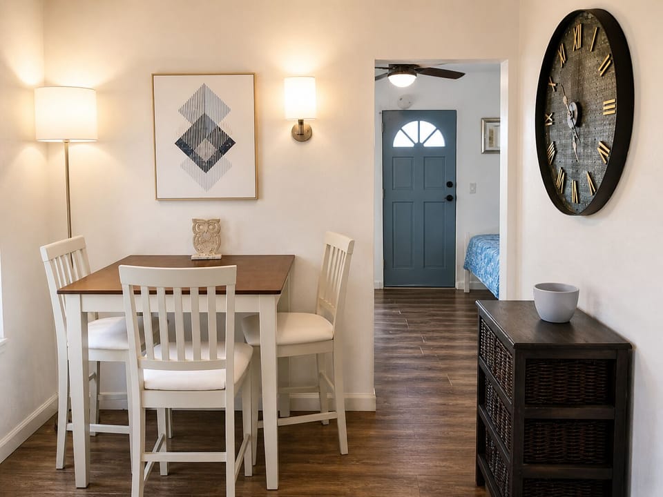 Cozy dining nook with chic lighting and wood floors near a calm bedroom