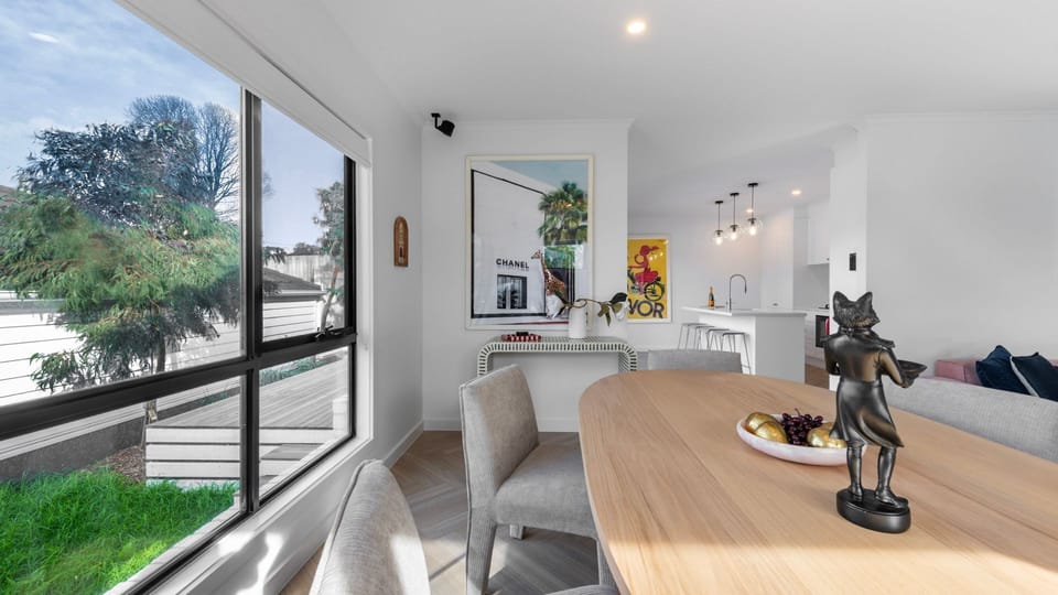 The open-plan layout flows seamlessly from the dining area to the stylish kitchen.