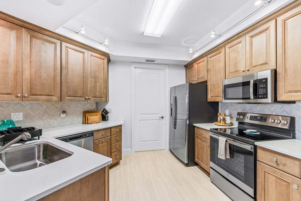 A spacious kitchen with bar seating—perfect for coffee, snacks, or family meals.
