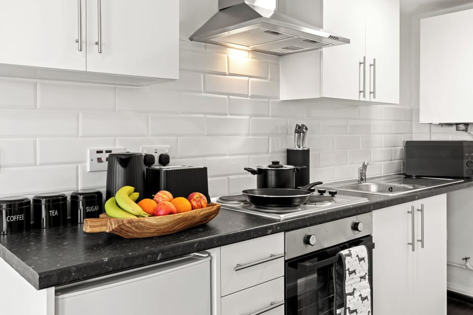 Sleek, fully equipped kitchen with subway tile and modern appliances