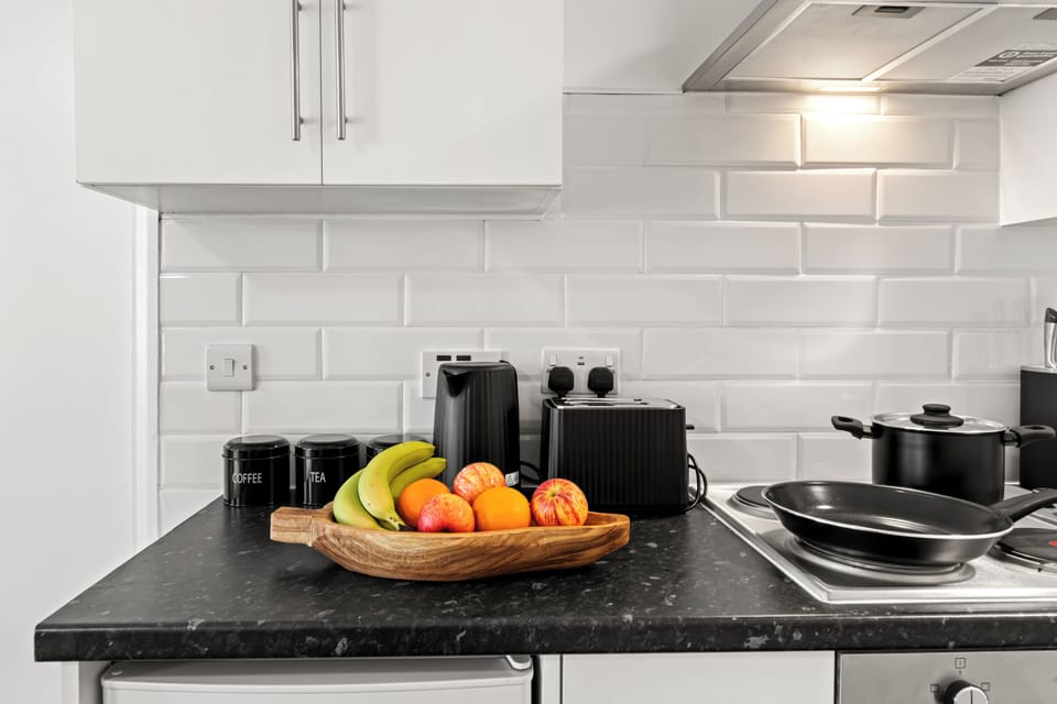 Modern kitchenette with appliances and cookware—ready to cook
