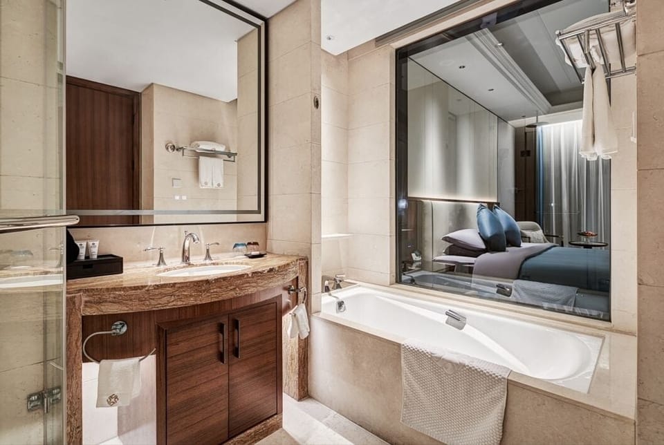 Separate tub and shower, hair dryer, slippers, towels