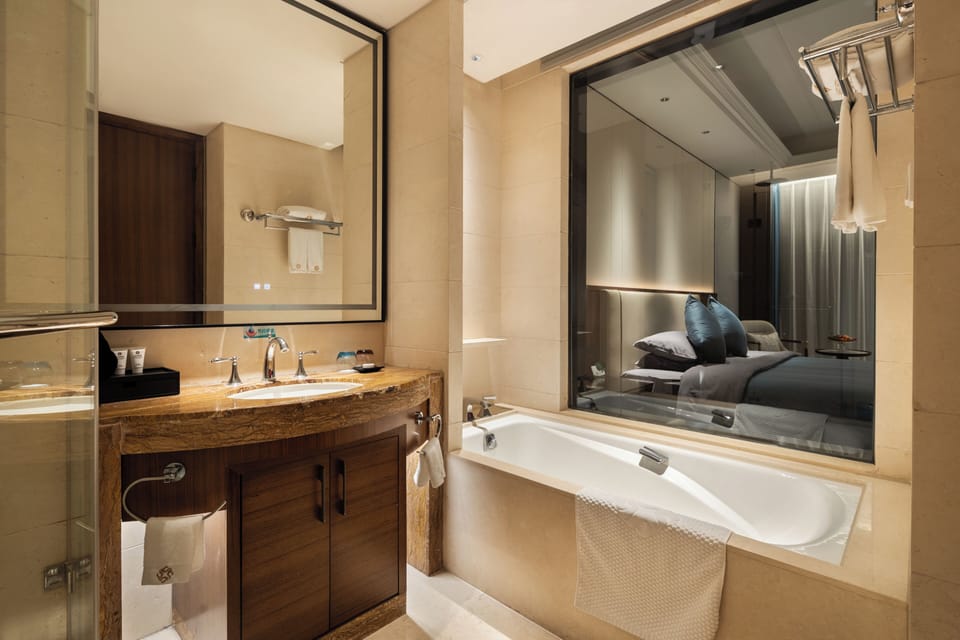 Separate tub and shower, hair dryer, slippers, towels