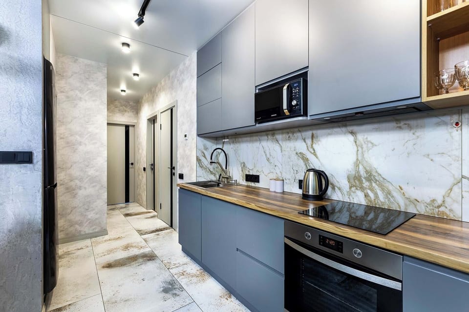 Luxury Apartment, Balcony, City View | Private kitchen | Electric kettle, griddle, cleaning supplies, freezer