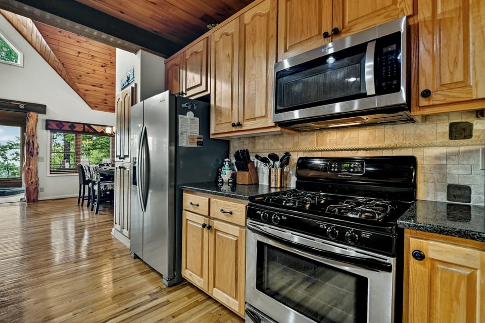 Granite countertops, stainless steel appliances, custom cabinetry, and thoughtful amenities combine to create a kitchen that's as beautiful as it is functional for your North Georgia mountain getaway