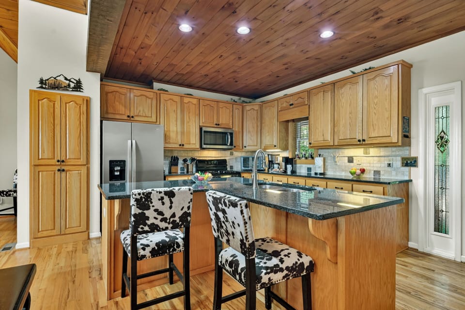 The oversized island provides additional prep space, extra seating, and a central gathering spot to sip some wine or a speciality cocktail
