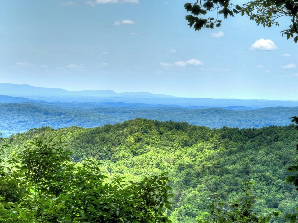 Take in breathtaking long-range mountain views from the back deck or sunroom