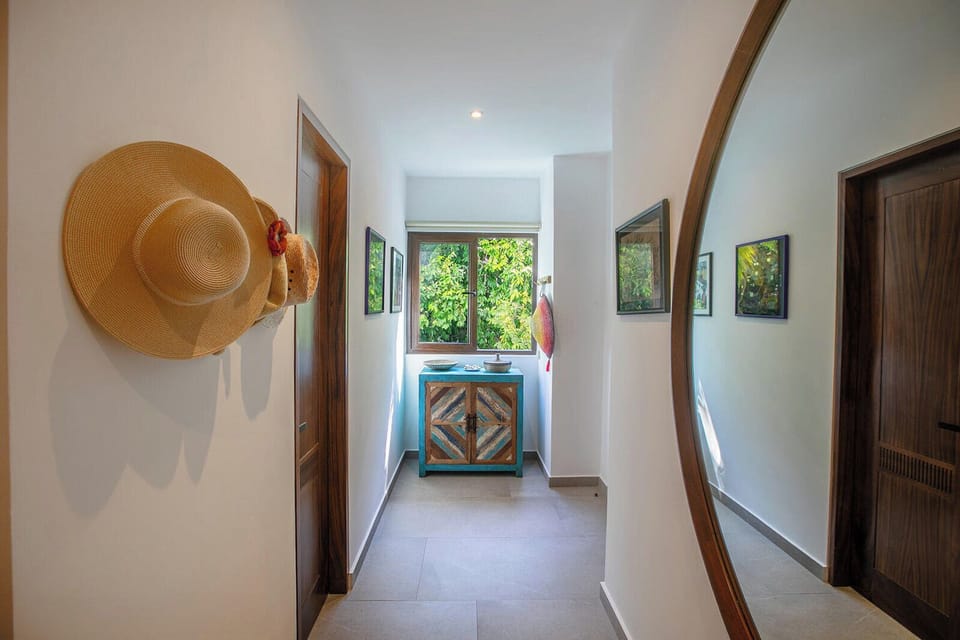Step into your private hallway, where natural light streams through the window, framing garden views