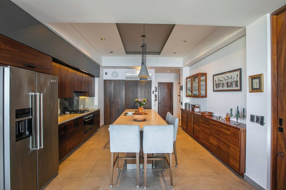 Fully equipped kitchen with sleek appliances and a central dining island
