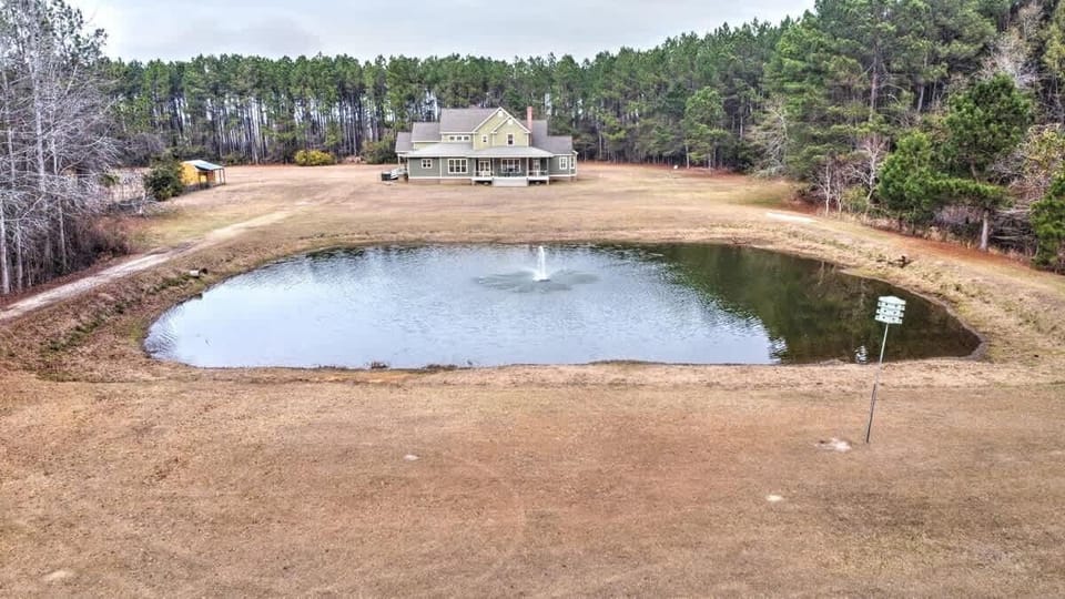 Enjoy peaceful pond views from The Grapevine House, set on 32 private acres with wide-open skies and vineyard charm.