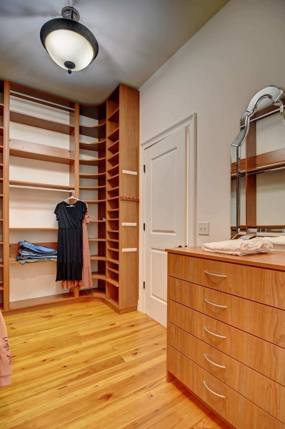 Spacious custom walk-in closet with built-in shelving and drawers — perfect for longer stays.