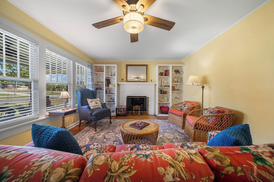 Sunny living room with fireplace, built-ins, and cozy seating
