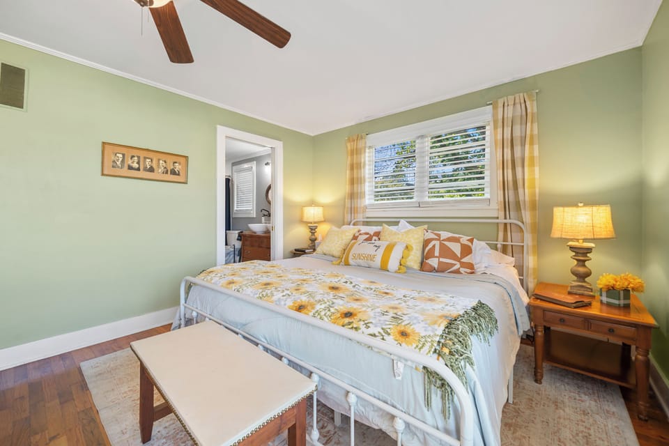 Sunny, cozy bedroom with floral accents and direct bathroom access