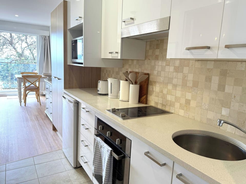Bright modern kitchen with full appliances and sunny dining nook
