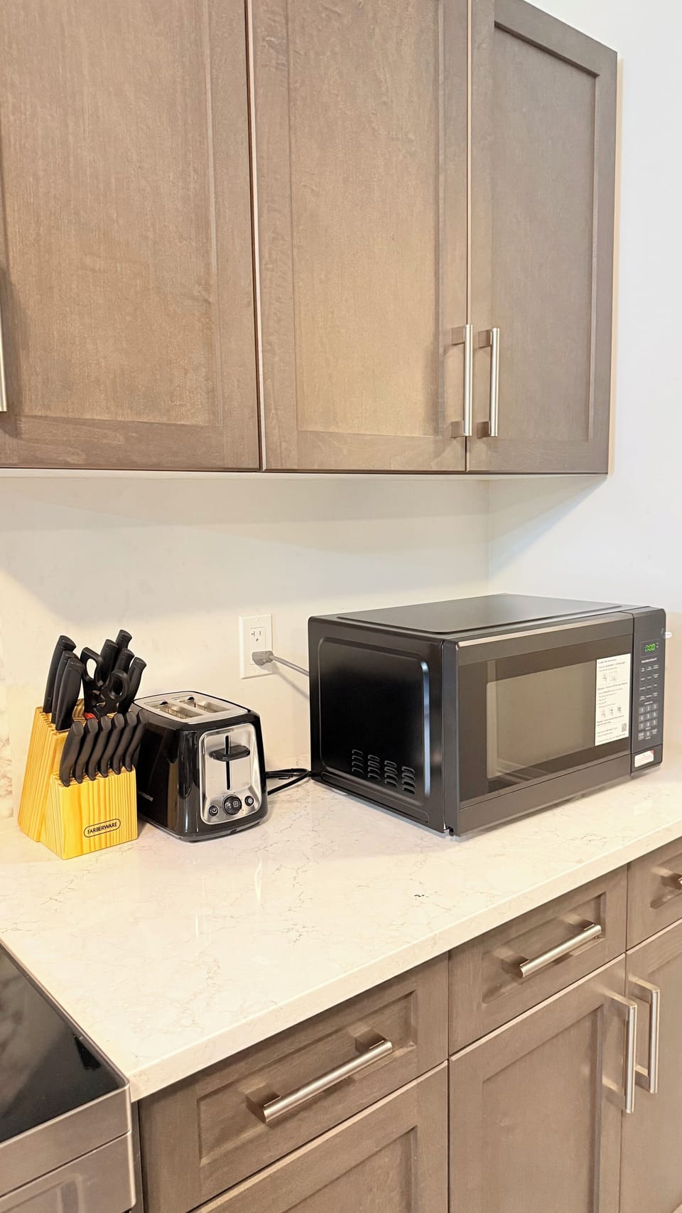 Kitchen has microwave, knives set, toaster
