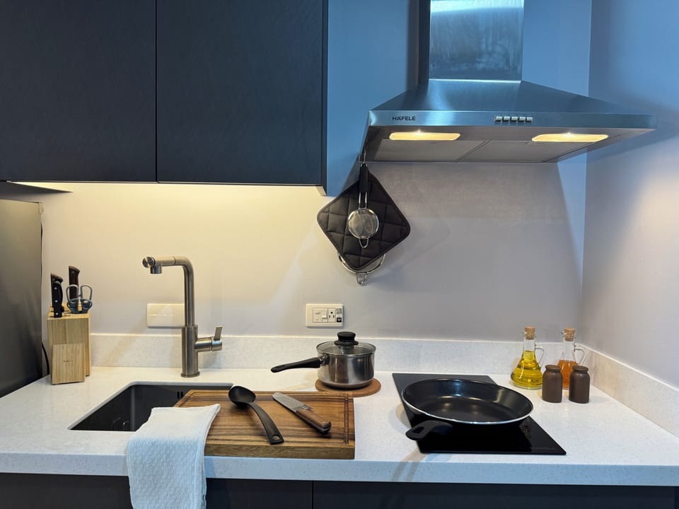 Sleek, fully equipped kitchenette with induction hob and vent hood