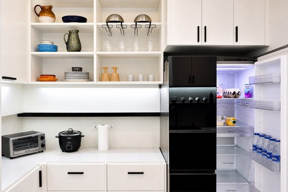 【Full Kitchen】Open shelving provides storage for glassware and dishes, arranged above a toaster oven and rice cooker, alongside an two-door LG fridge. Please note that water and all food provisions are not provided.