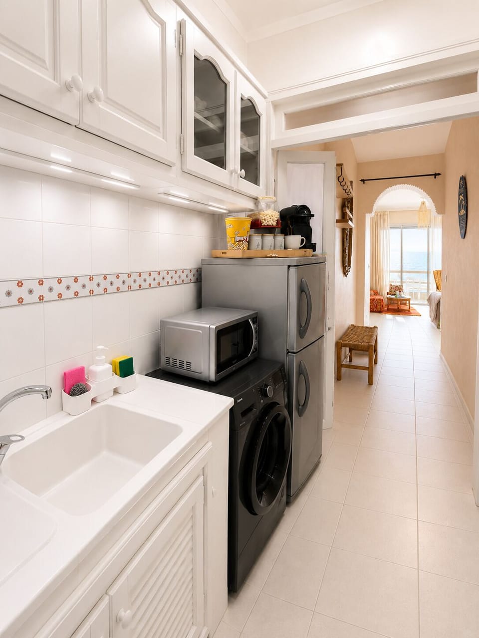 Fully equipped kitchen with everything you need with a glimpse of the ocean view. Thoughtfully stocked and perfect for home-cooked meals.