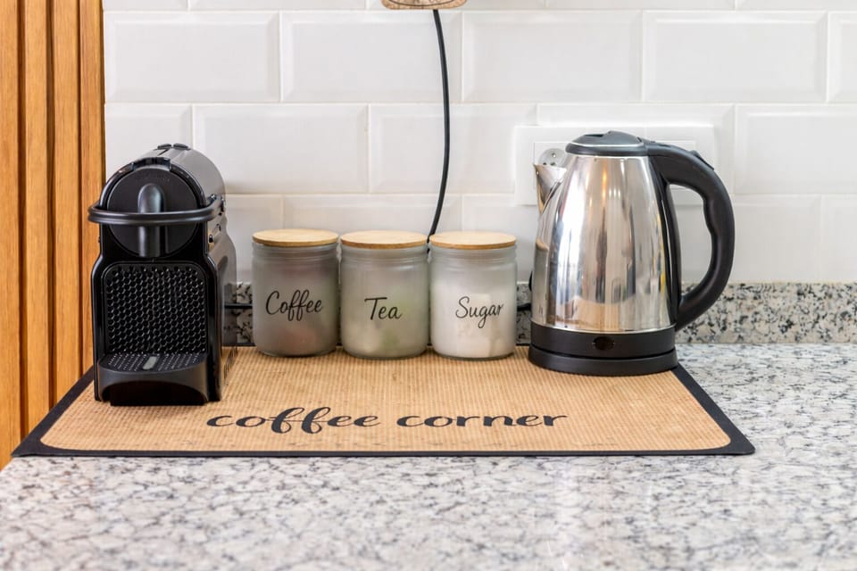 Cozy coffee station with Nespresso machine, coffee capsules, tea and sugar provided for your comfort
