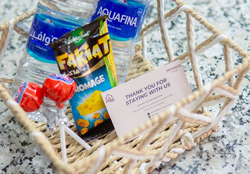 Complimentary welcome basket with water, snacks, and sweet treats