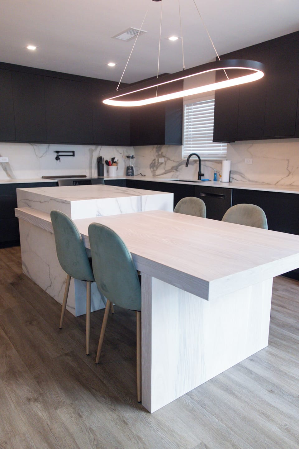 Stylish modern kitchen with waterfall island and designer lighting