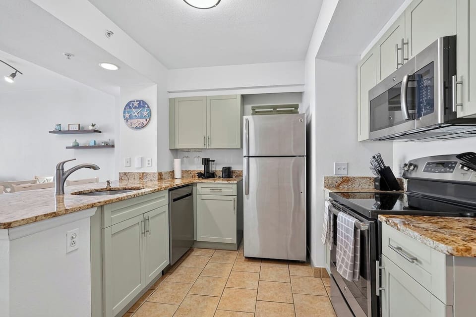 Full equipped kitchen with pans and spices.