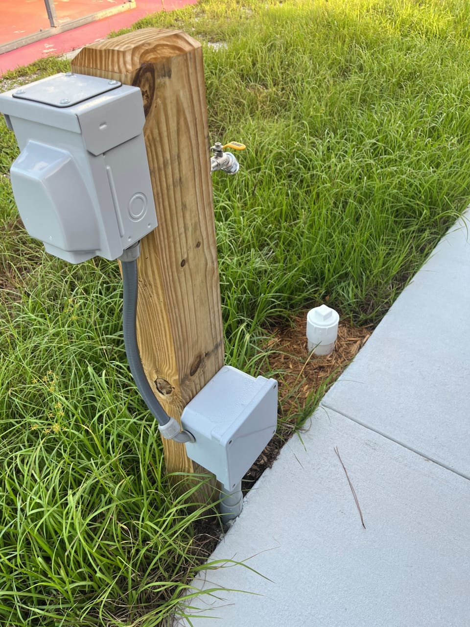 RV setup includes electric, water and sanitary dump by RV parking pad. 