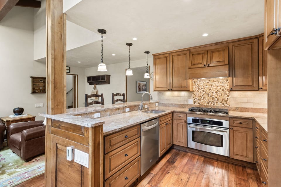 The kitchen features beautiful granite countertops and new stainless steel appliances.