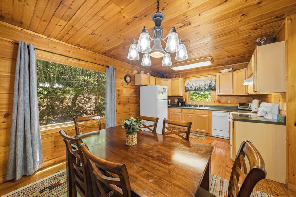 Cozy woodsy kitchen and dining space with forest views and cabin charm