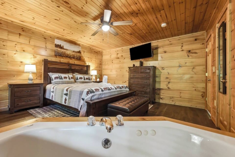 Rustic king suite with jetted tub and warm cabin charm