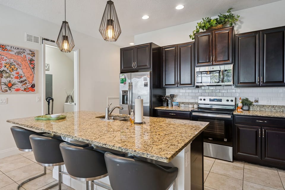 Spacious kitchen with granite counters and breakfast bar 