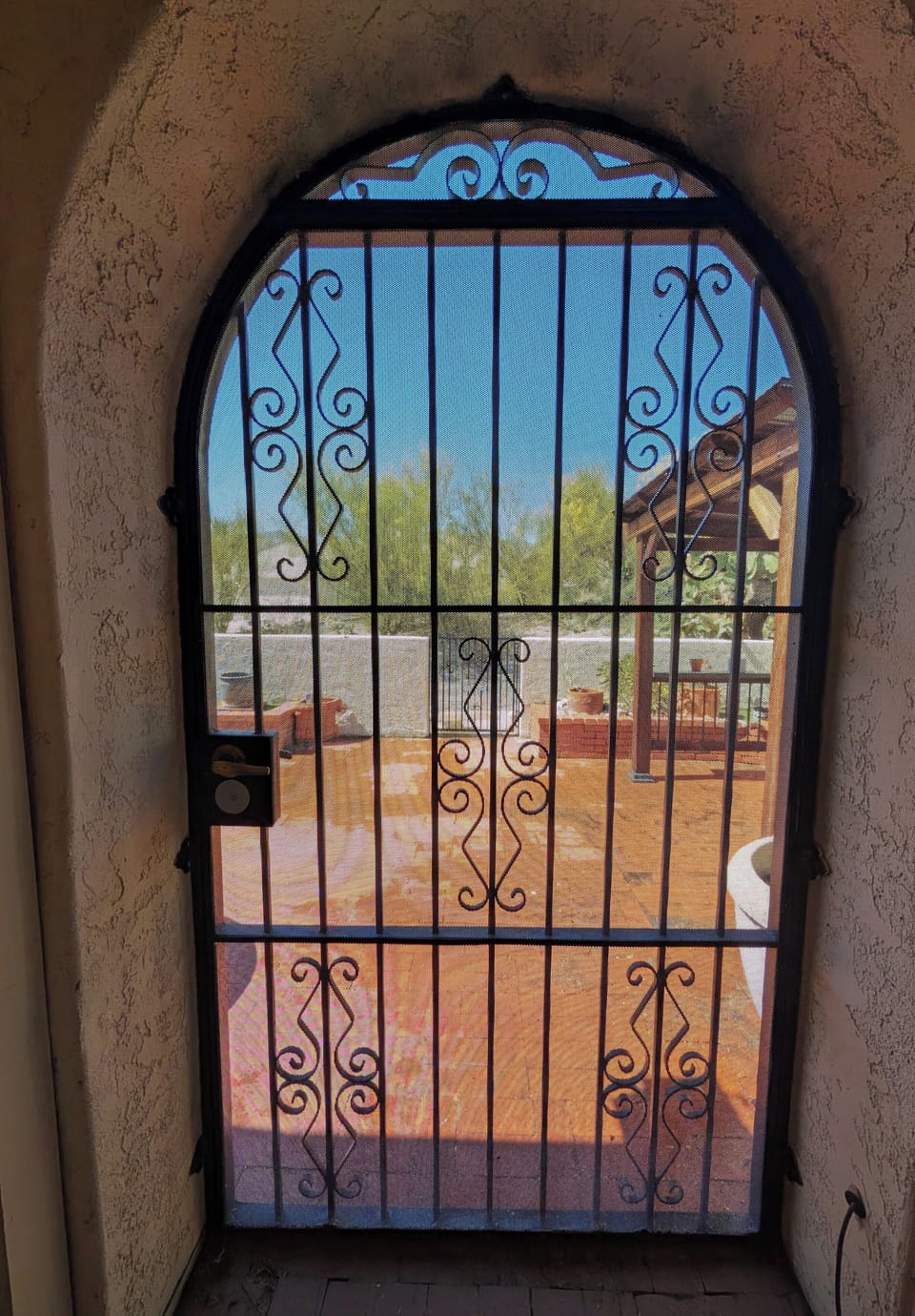Iron gate to back yard seating area. 