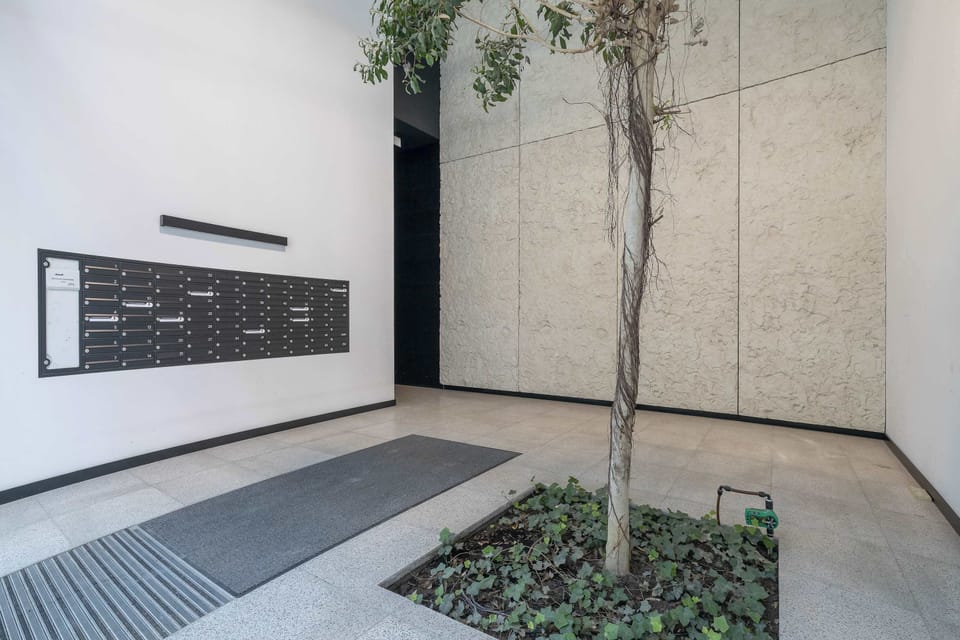 The apartment building features a modern and secure entrance. Contemporary architecture creates a welcoming first impression.