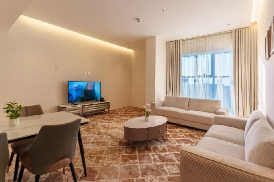 Family Suite, City View | Living area | 65-inch Smart TV with cable channels